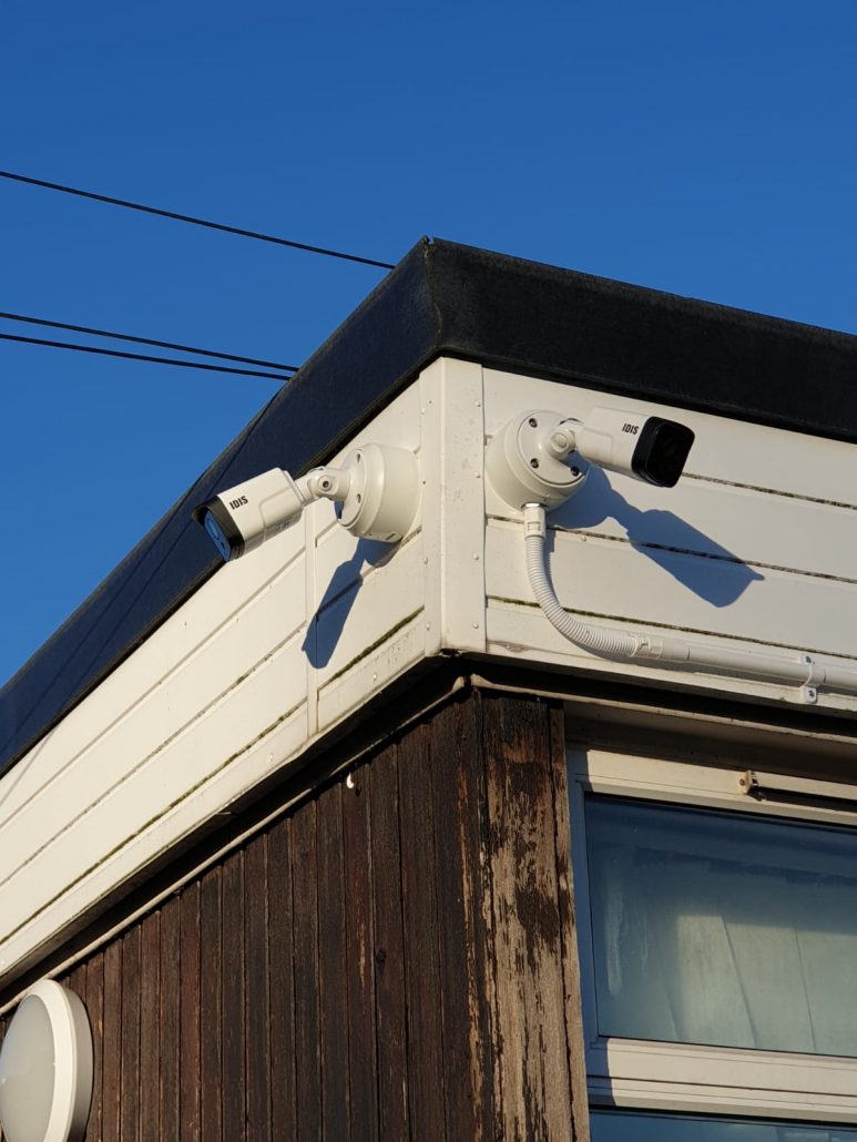 double cctv camera against a blue sky