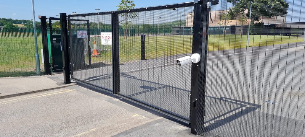 Black automatic gate fitted with cctv by Unison